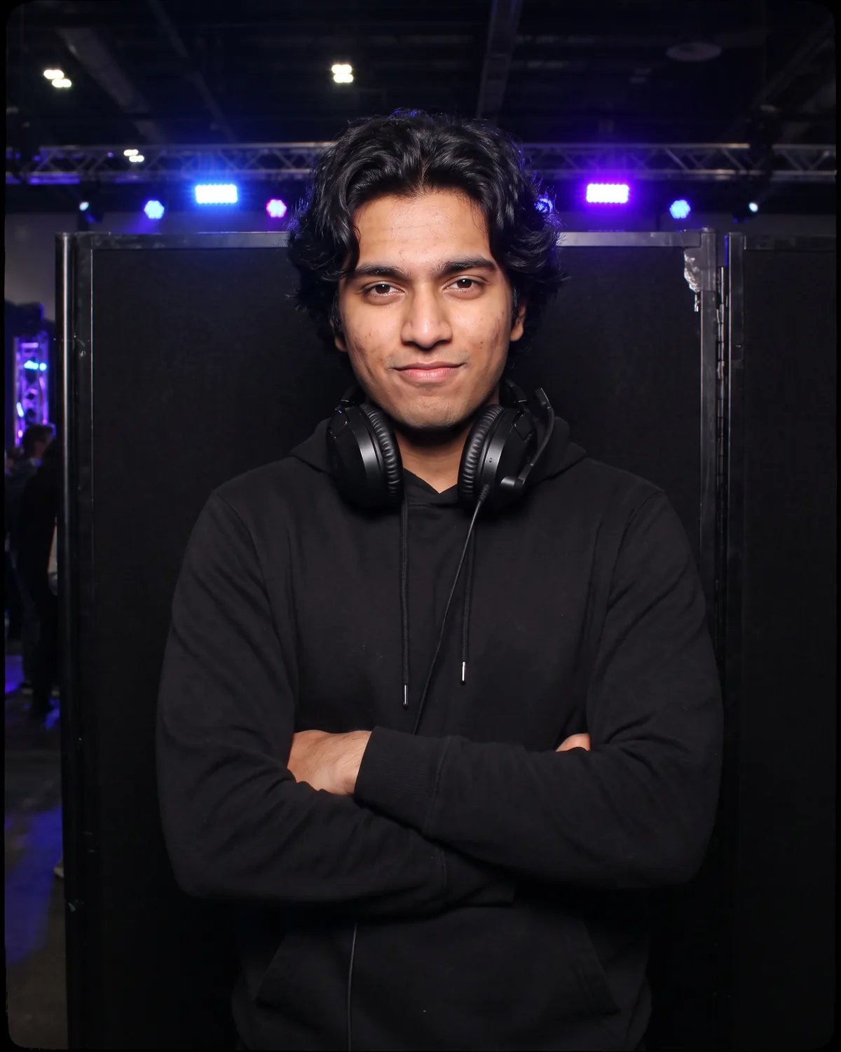 Player at a gaming tournament with a headset around his neck
