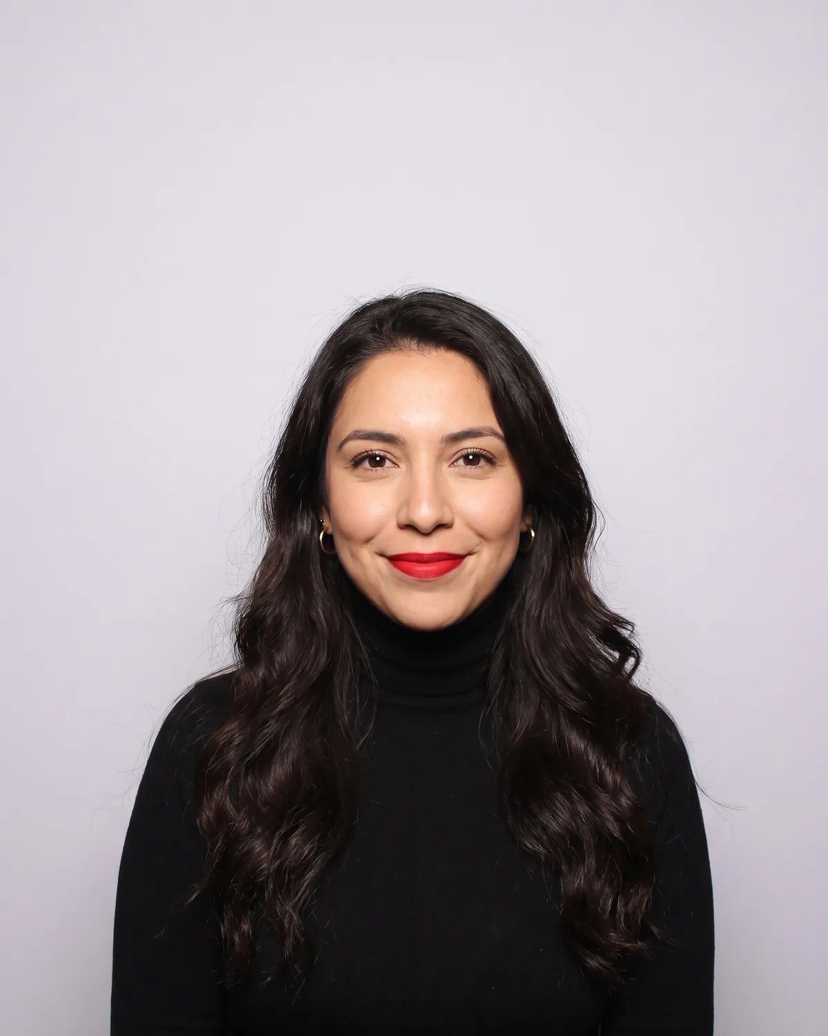 Guest at a brand launch in a black turtleneck, photographed by the booth