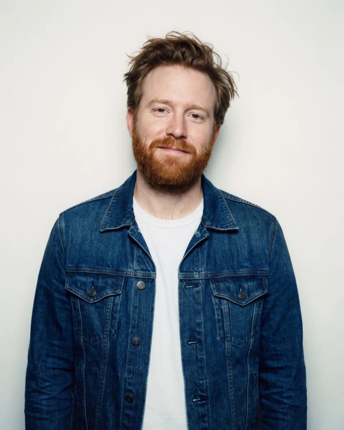 Guest at a fashion launch in a denim jacket and white tee