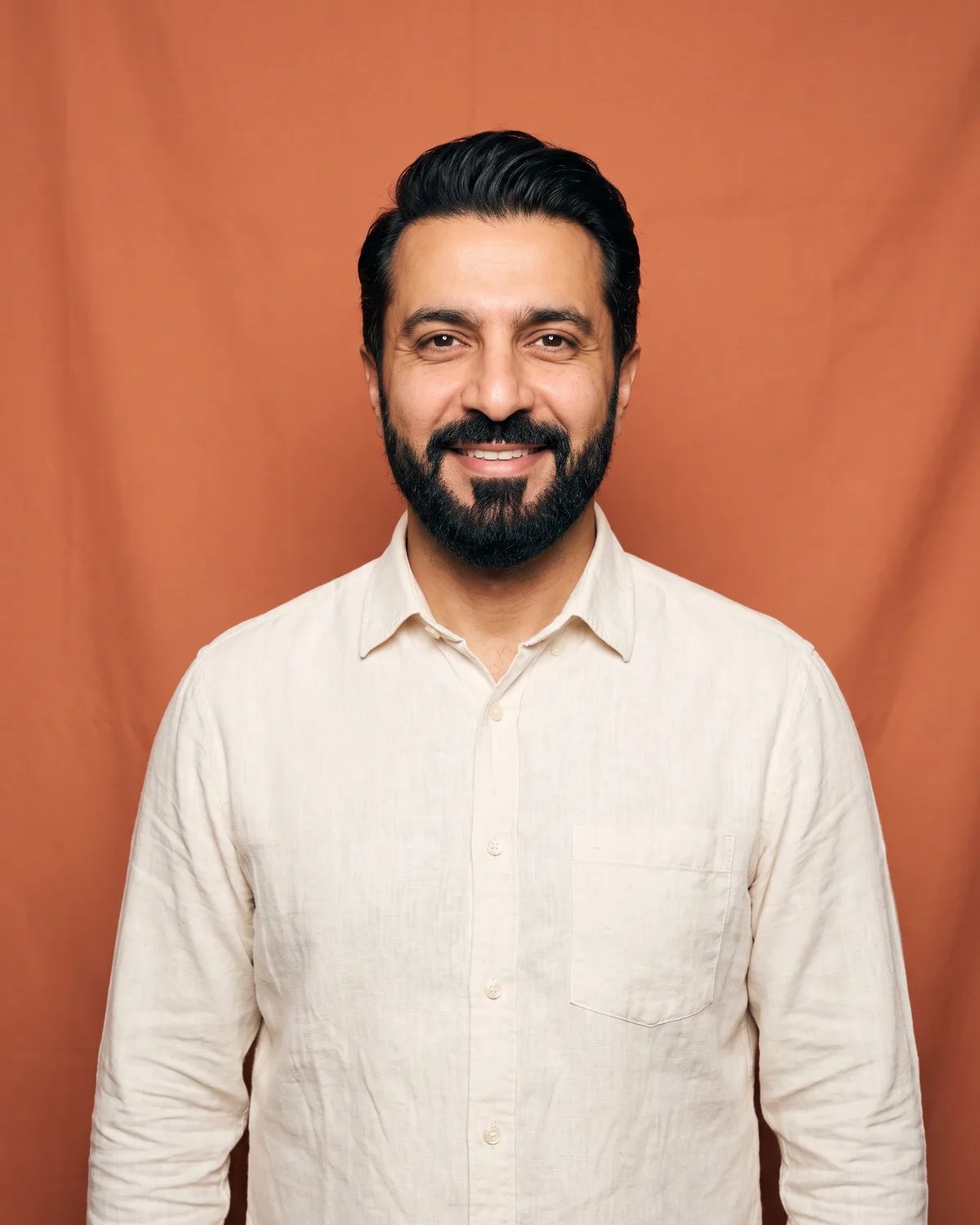 Guest at a hotel opening in a cream linen shirt