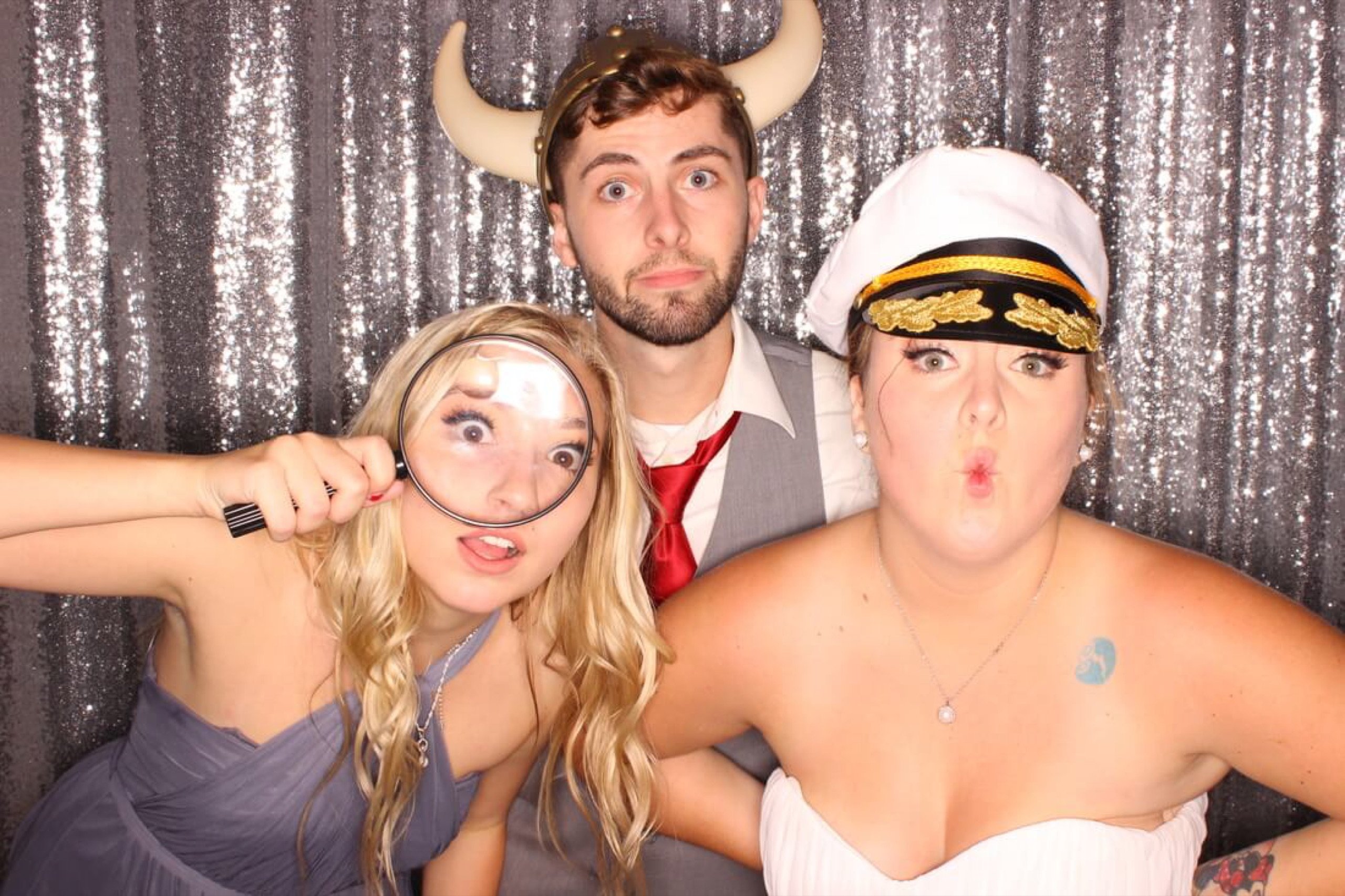 Wedding guests in viking horns and a captain's hat mugging for the booth at Morgan and Cory's wedding at Reflections at the Buttes