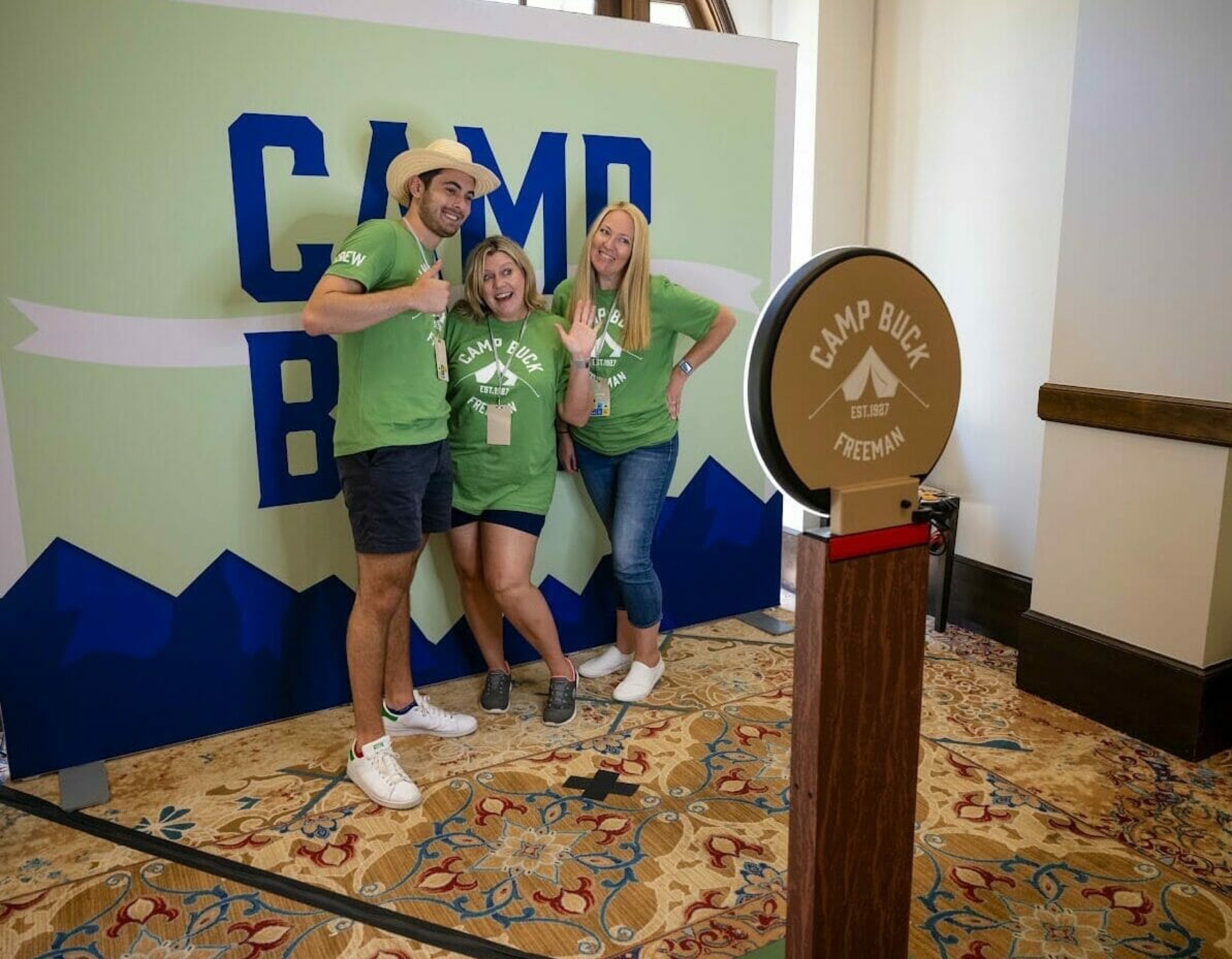 Guests posing at a selfie station rental set up for a corporate retreat