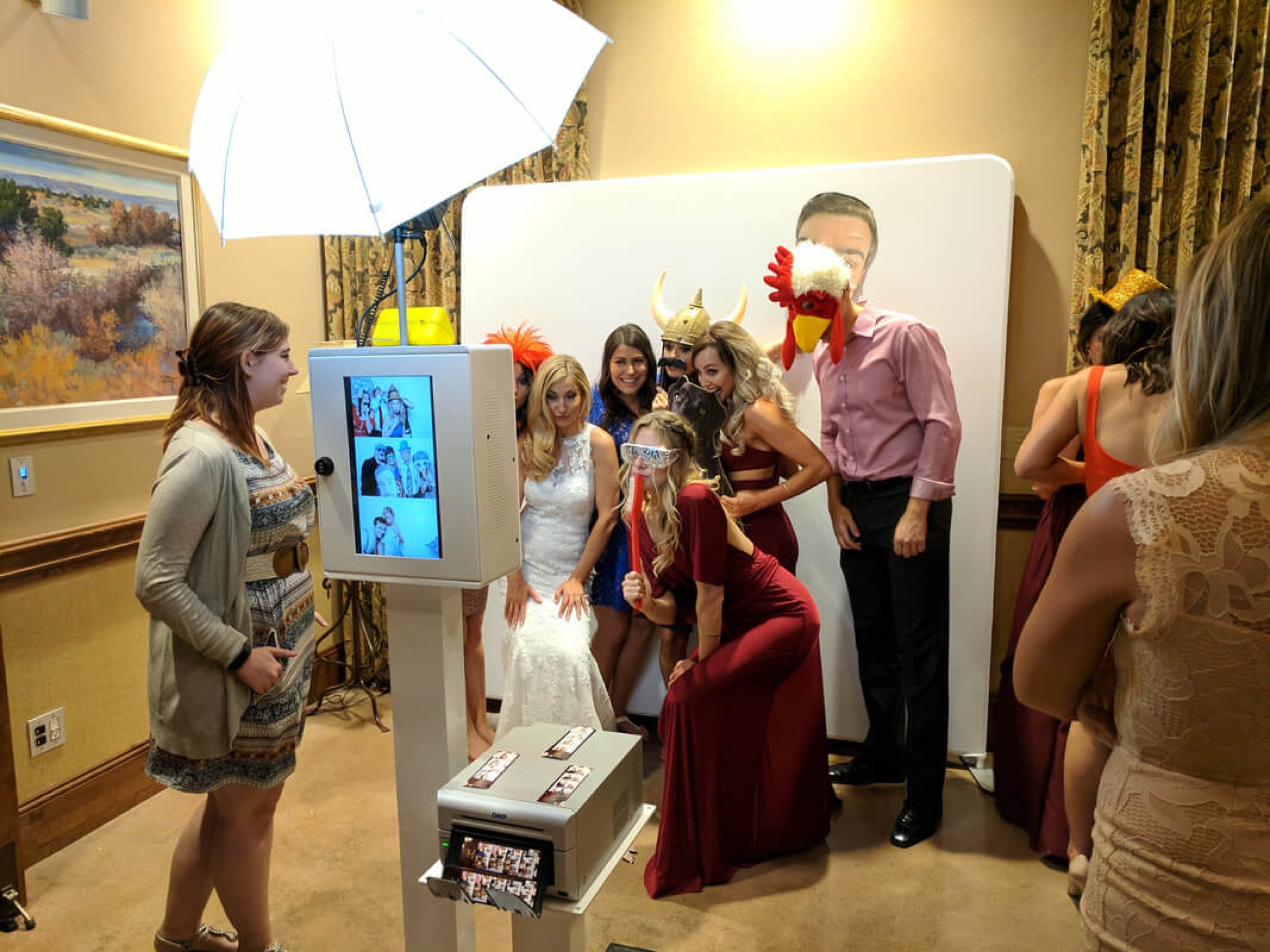 Bride and her wedding party crowding into the photo booth in props at Hacienda del Sol Resort in Tucson