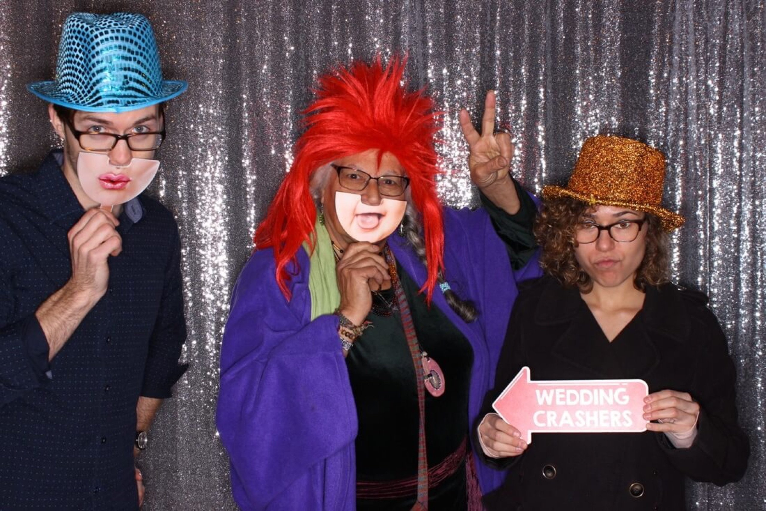 Guests in wigs, hats, and a Wedding Crashers prop sign at the Stillwell House and Garden wedding in downtown Tucson, February 18, 2017