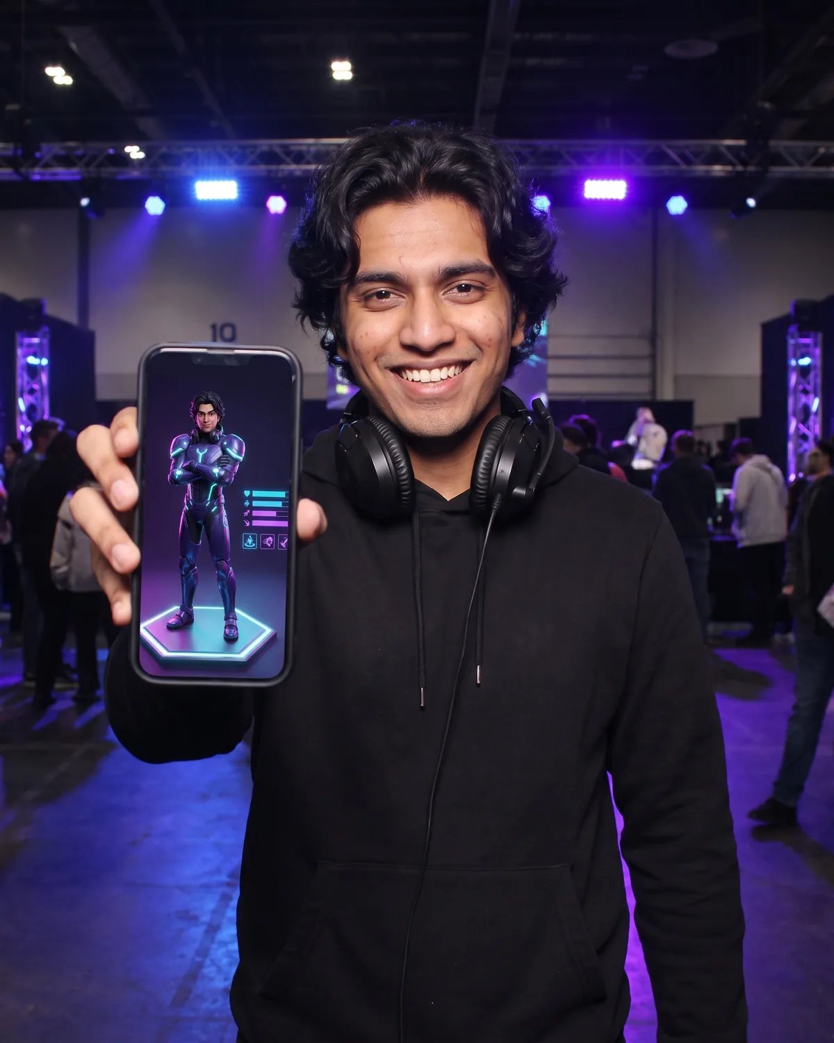 A player at a gaming tournament showing his game character on his phone