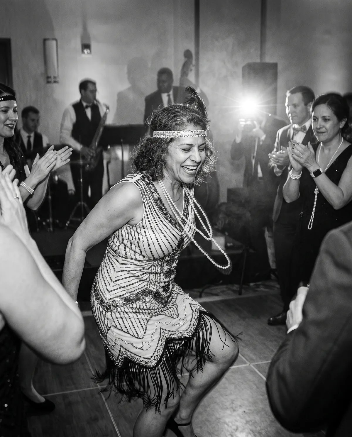 The gala guest dancing the Charleston in a beaded flapper dress, in black and white