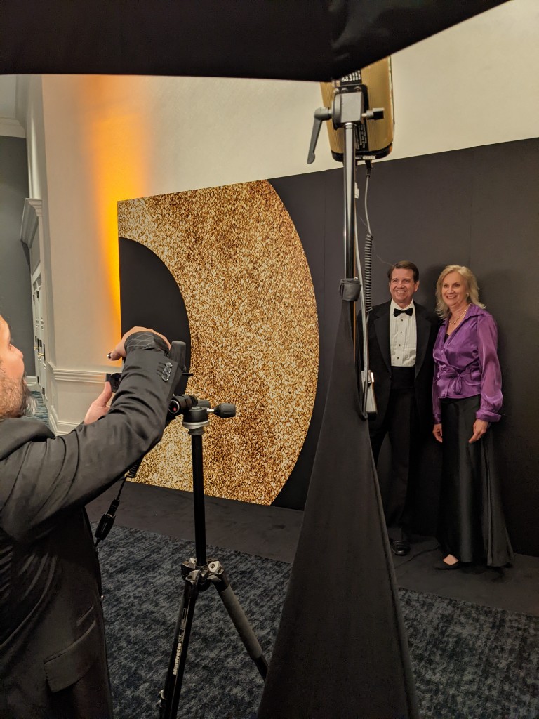 Behind the scenes at a formal step-and-repeat portrait setup