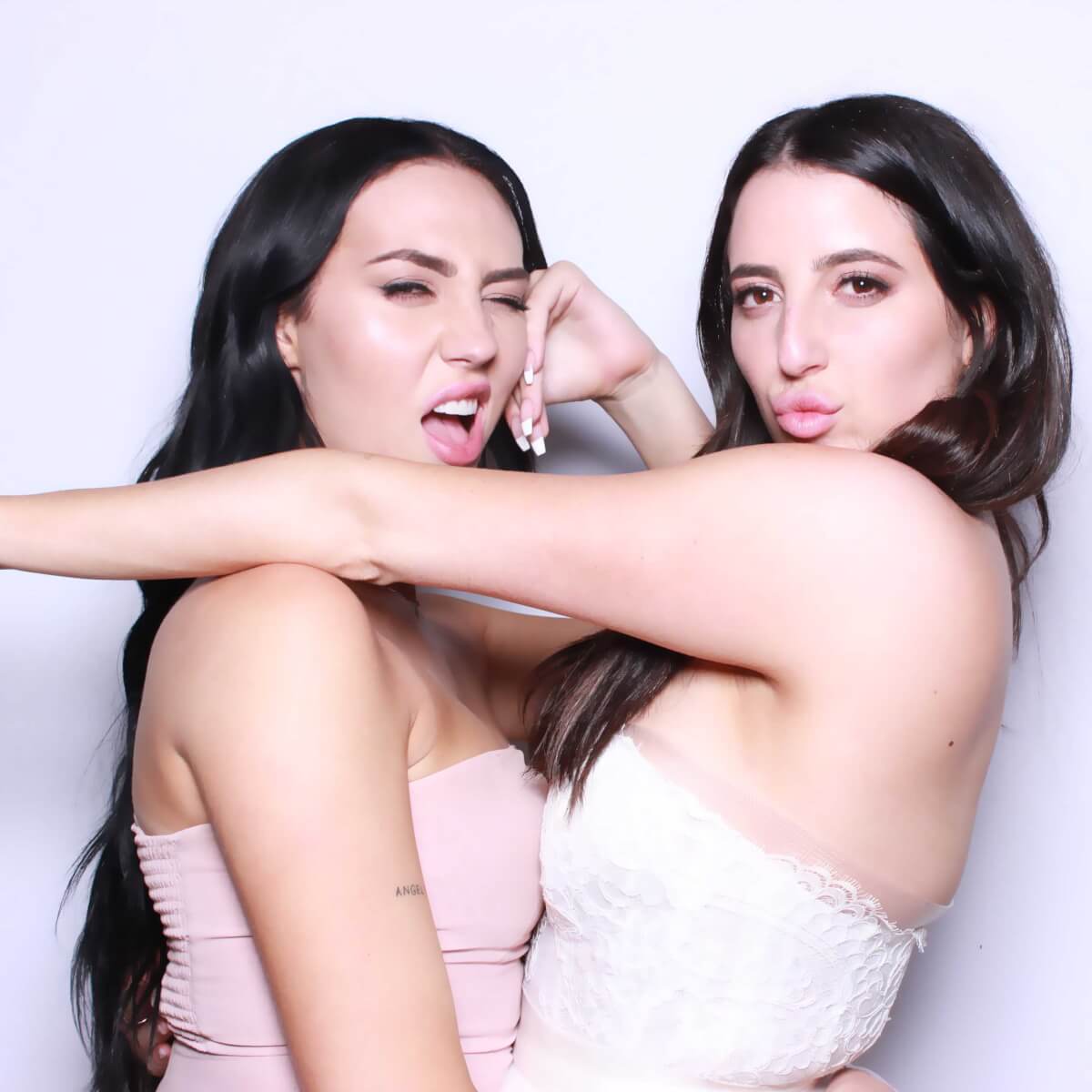 Guests posing together in the glam booth's bright white light