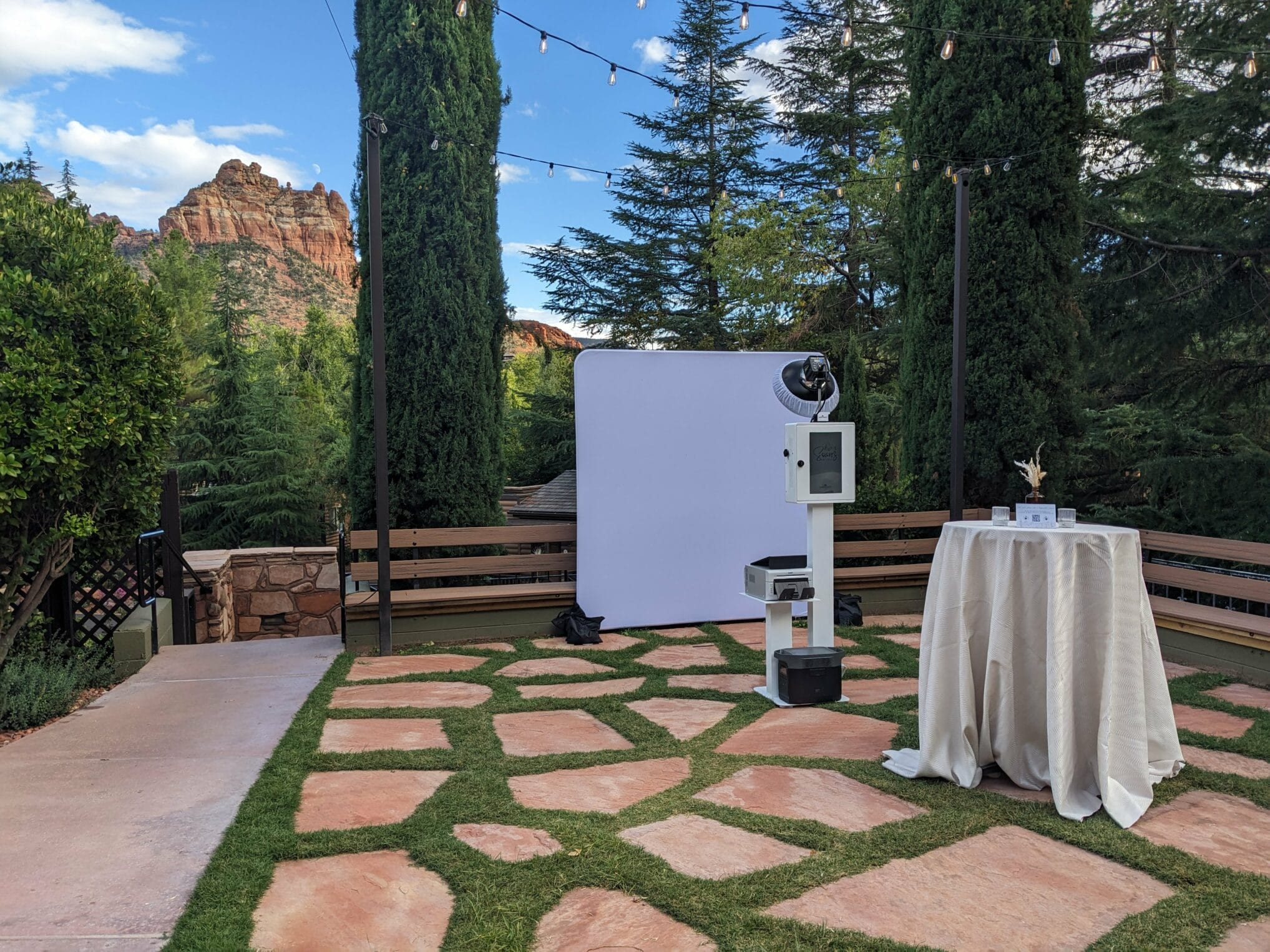 The glam booth set up outdoors under string lights against Sedona's red rocks