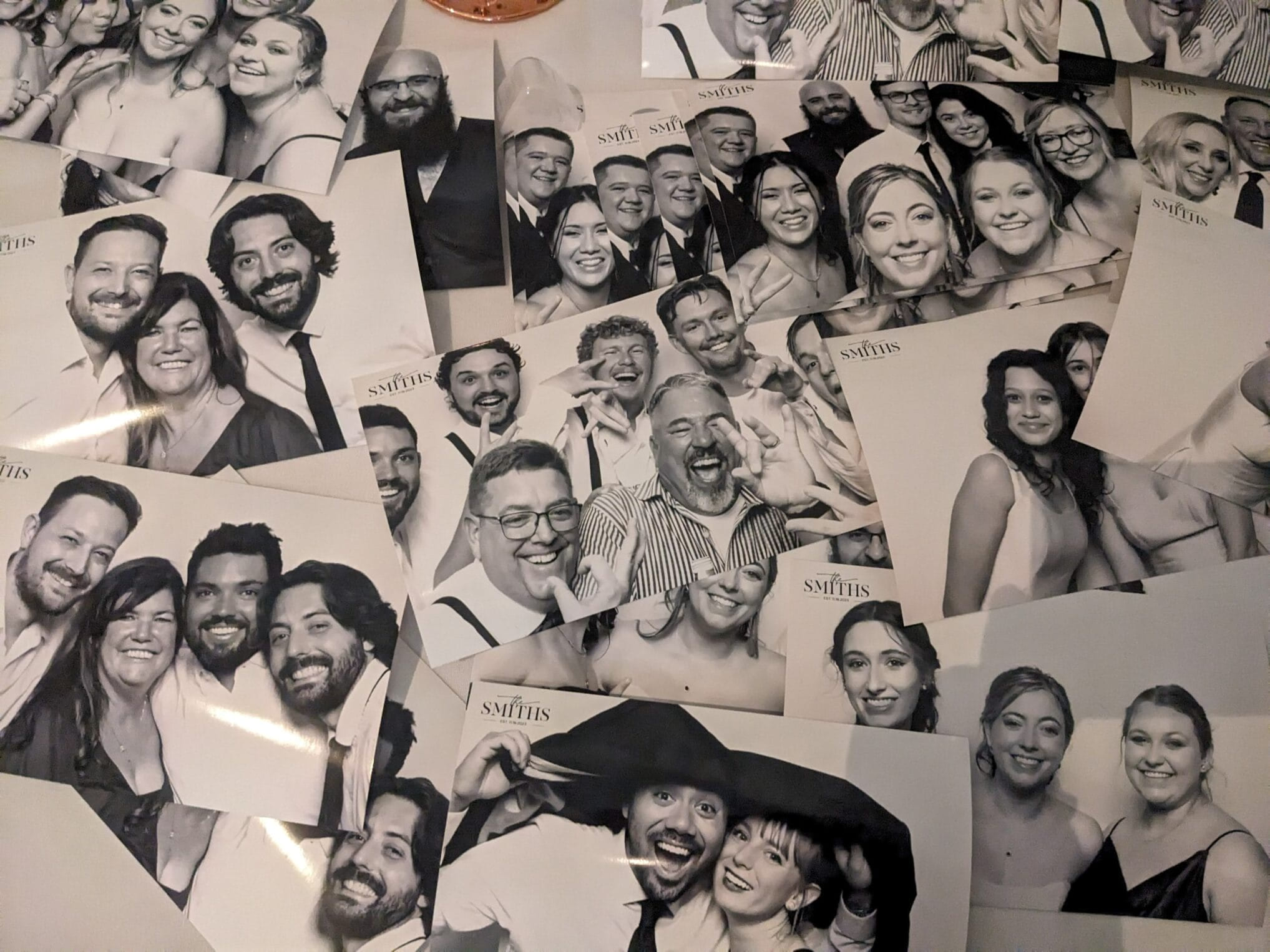 A table covered in black and white glam prints from a wedding