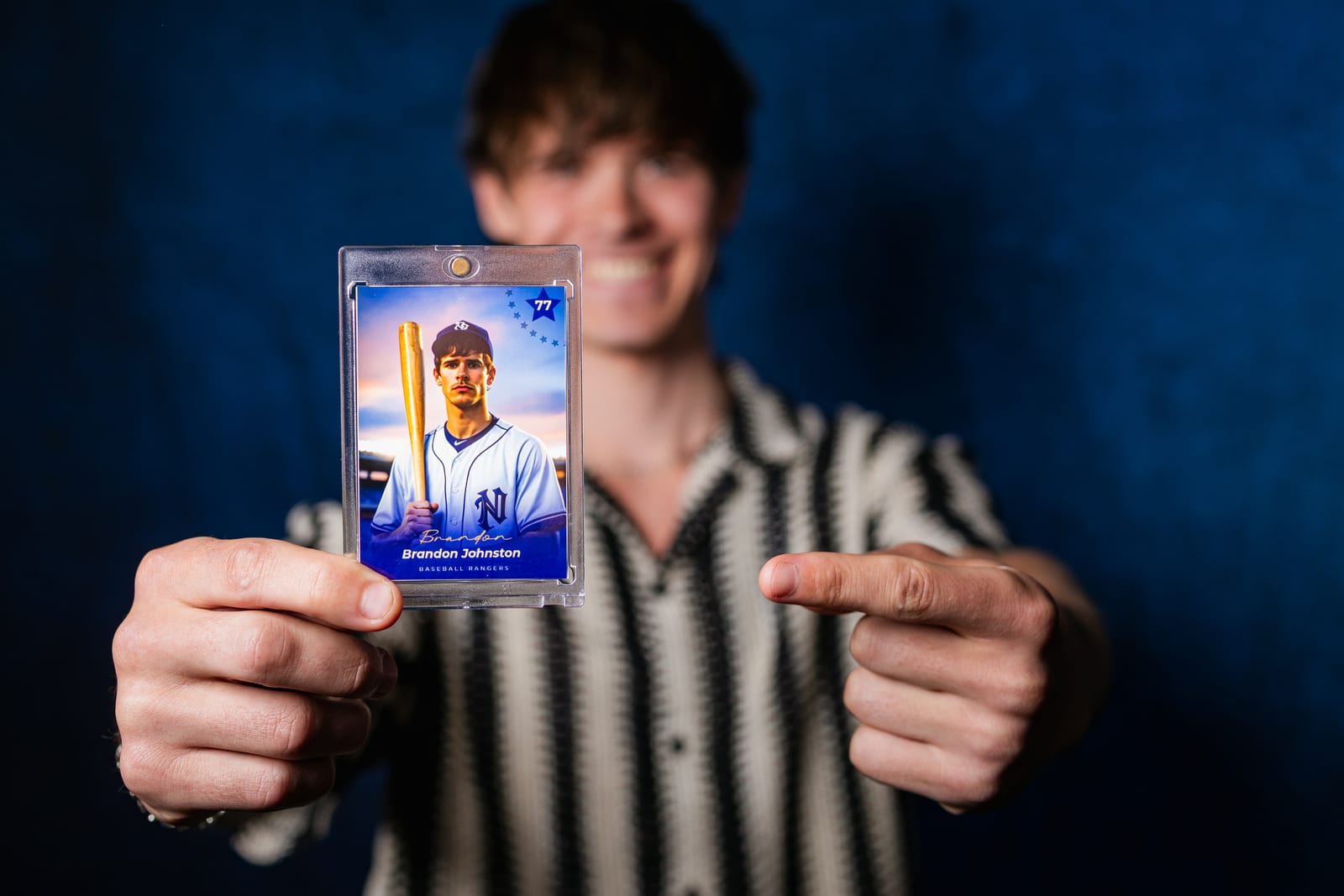 A guest pointing at his own printed baseball trading card